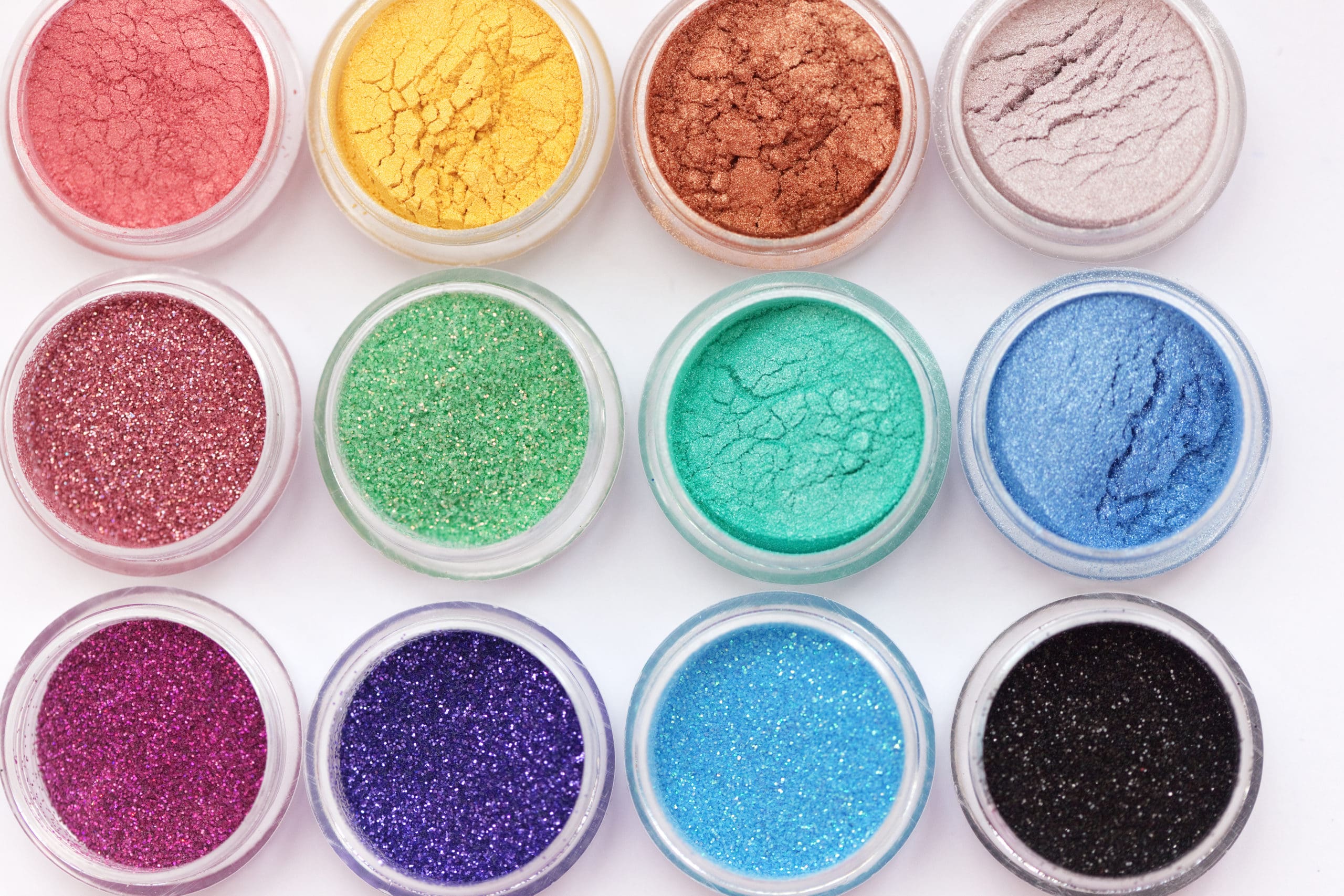 Display of brightly colored pigments for skincare in small containers