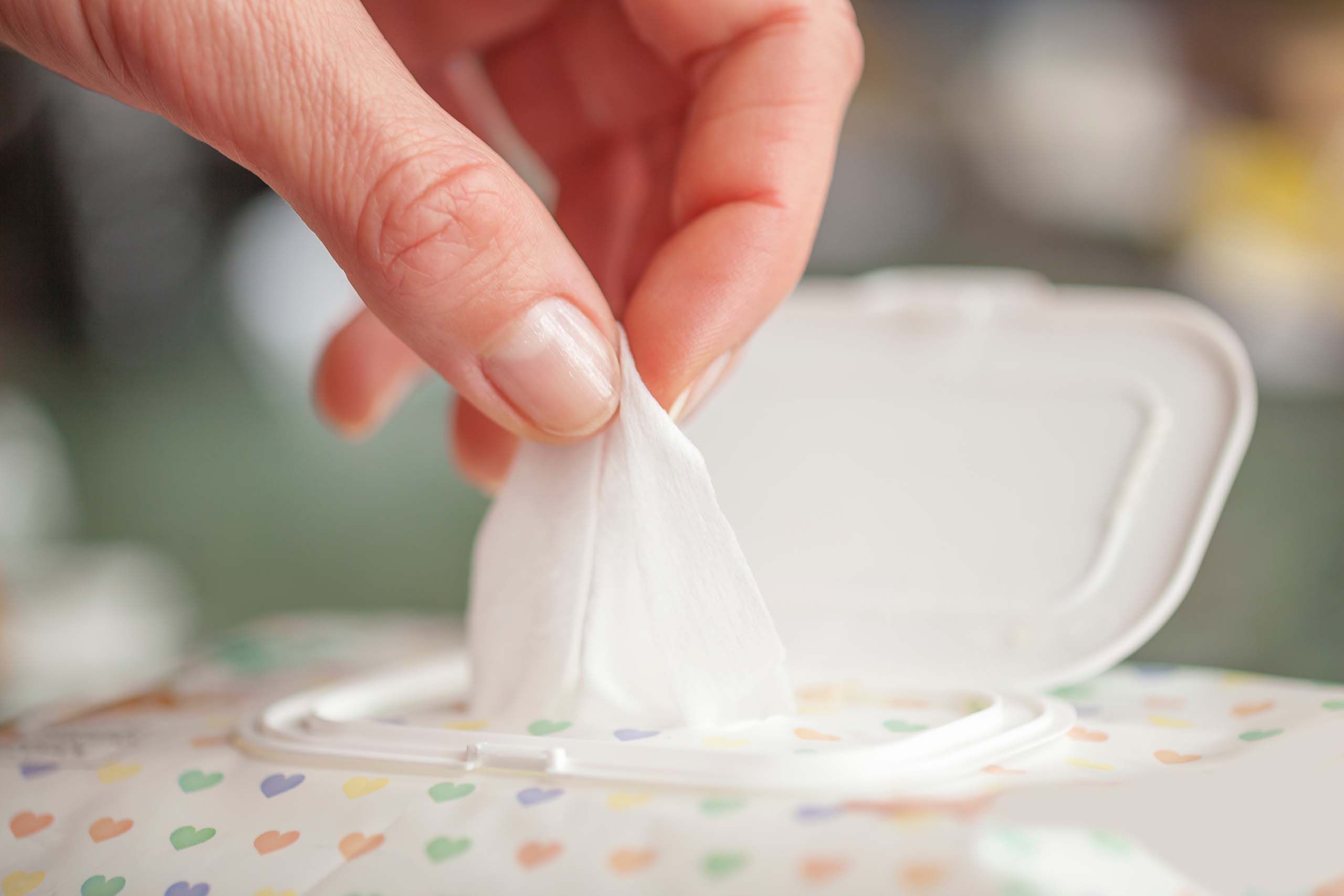 Pulling out cleaning wipe from container