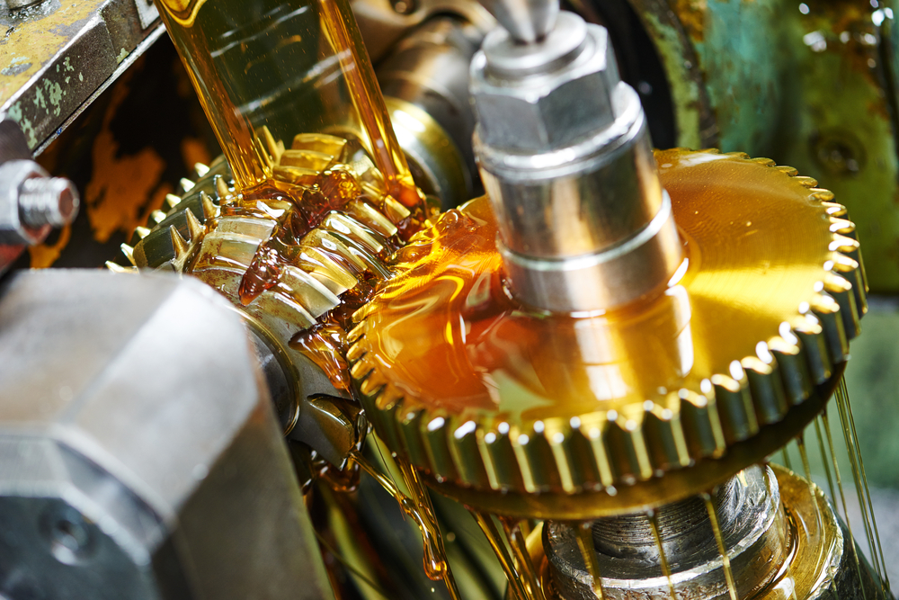 A close up of a gear with oil lubricant pouring out of it
